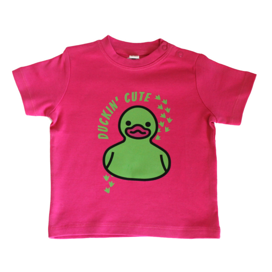 Bright pink baby t-shirt with cartoon duck and bold 'Duckin’ Cute' text – fun and cheeky design for toddlers.